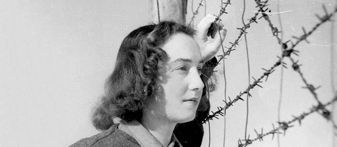 Yalina Lebovicova standing by the barbed wire in the Nováky forced labor camp, Slovakia. Yalina was an actress in the camp’s theater Yalina Lebovicova standing by the barbed wire in the Nováky forced labor camp, Slovakia. Yalina was an actress in the camp’s theater