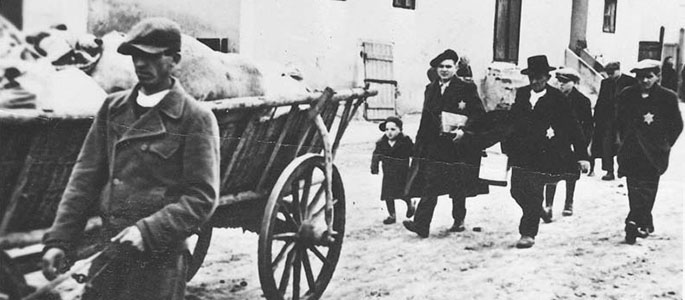 Jews walking next to carts loaded with their personal effects, being deported from Slovakia, 1942 Jews walking next to carts loaded with their personal effects, being deported from Slovakia, 1942