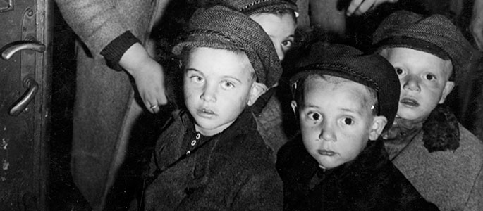 Child survivors of the Holocaust with their chaperone, in Czechoslovakia, about to board a train bound for Western Europe Child survivors of the Holocaust with their chaperone, in Czechoslovakia, about to board a train bound for Western Europe