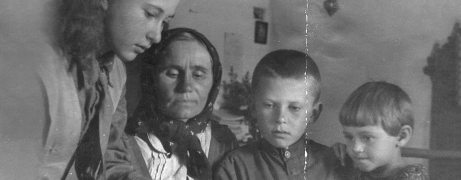 Eldina reading a book to Ludwiga (Nina), Gennady and Galya, September, 1946