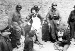 German military sappers (combat engineers), charged with exposing and breaking into underground bunkers, photographed with Jews who had been in hiding within such a bunker. Likely taken on 8 May 1943 German military sappers (combat engineers), charged with exposing and breaking into underground bunkers, photographed with Jews who had been in hiding within such a bunker. Likely taken on 8 May 1943
