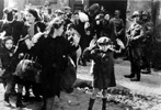 German soldiers threatening women and children with their weapons during the liquidation of the Warsaw Ghetto German soldiers threatening women and children with their weapons during the liquidation of the Warsaw Ghetto