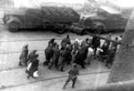 Jews being deported during the suppression of the Warsaw Ghetto uprising, under the supervision of SS men, 20 April 1943. Photographed through the window of a building near the ghetto by Leszek Grzywaczewski, a firefighter who was also a member of the Polish underground Jews being deported during the suppression of the Warsaw Ghetto uprising, under the supervision of SS men, 20 April 1943. Photographed through the window of a building near the ghetto by Leszek Grzywaczewski, a firefighter who was also a member of the Polish underground