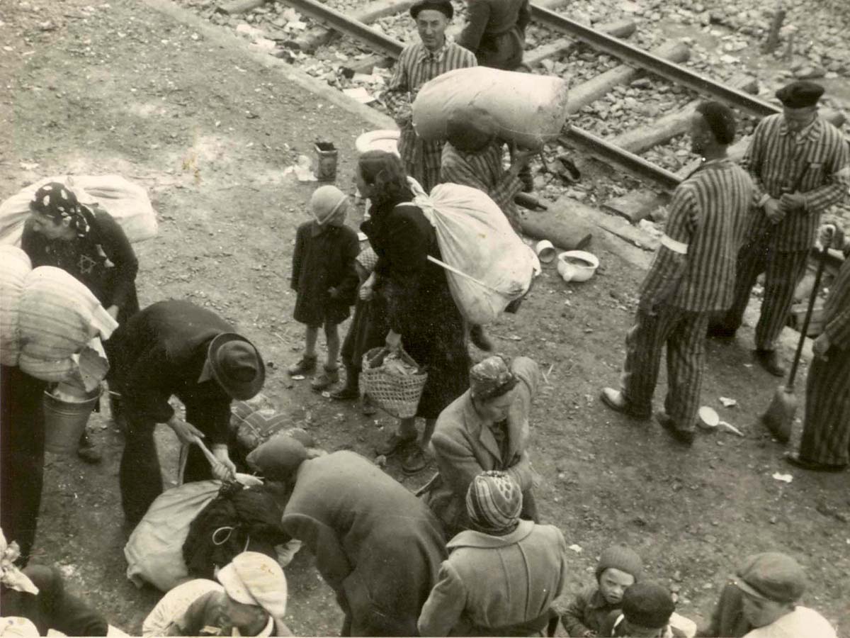 The Jews who just arrived are taking care of their property as they are under the assumption they will be needing it. They have no idea that most of them will be murdered, and their property appropriated by the Nazis