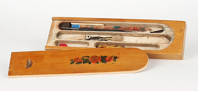 Wooden pencil box containing pencils and other writing utensils used by young Mira Kristianpolerow from Probuzna, Poland