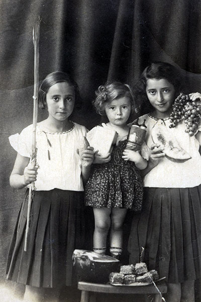 Prewar, Obertyn, Poland, Sonja Shulamit, Donia, and Esther Serger during the Sukkot holiday