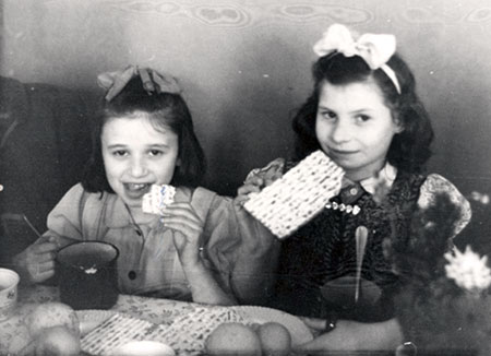 Girls eating matzah on Passover at the Rothschild Center, Vienna, Austria, postwar