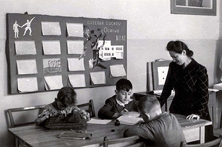 Students and their teacher Franciszka Oliwa in a classroom at the children's home in Otwock, postwar
