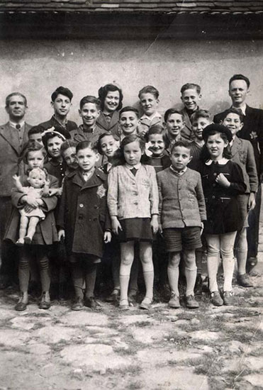 Vera and Jiri Bader with pupils and teachers at the Jewish school where they studied during the period of the Nazi occupation in Kyjov, Czechoslovakia