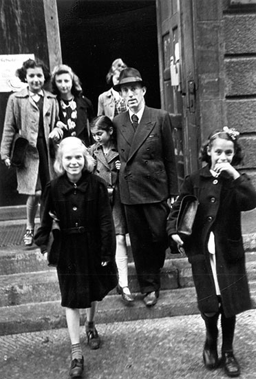 A Jewish teacher brings his daughter to a school in a DP camp, Berlin, Germany, postwar