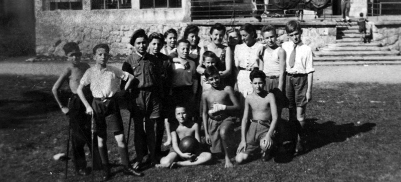 Lena Küchler (center) with the children and staff at the children's home in Zakopane.  Poland, 1945
