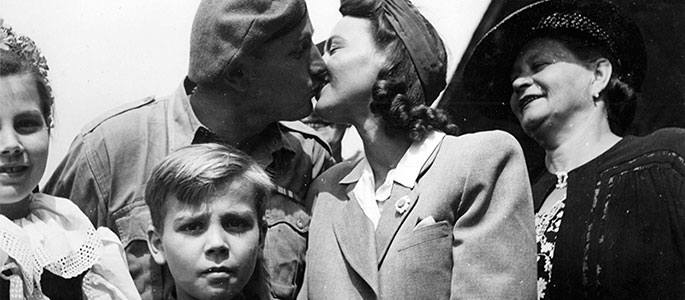 Holocaust survivor bids farewell to a soldier from the Jewish Brigade at a train station along the route of the Bricha. Czechoslovakia