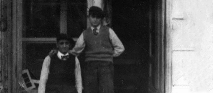 Two Jewish men standing in front of a tailor’s shop in Bratislava before the war. One of them is Jacob Guterman