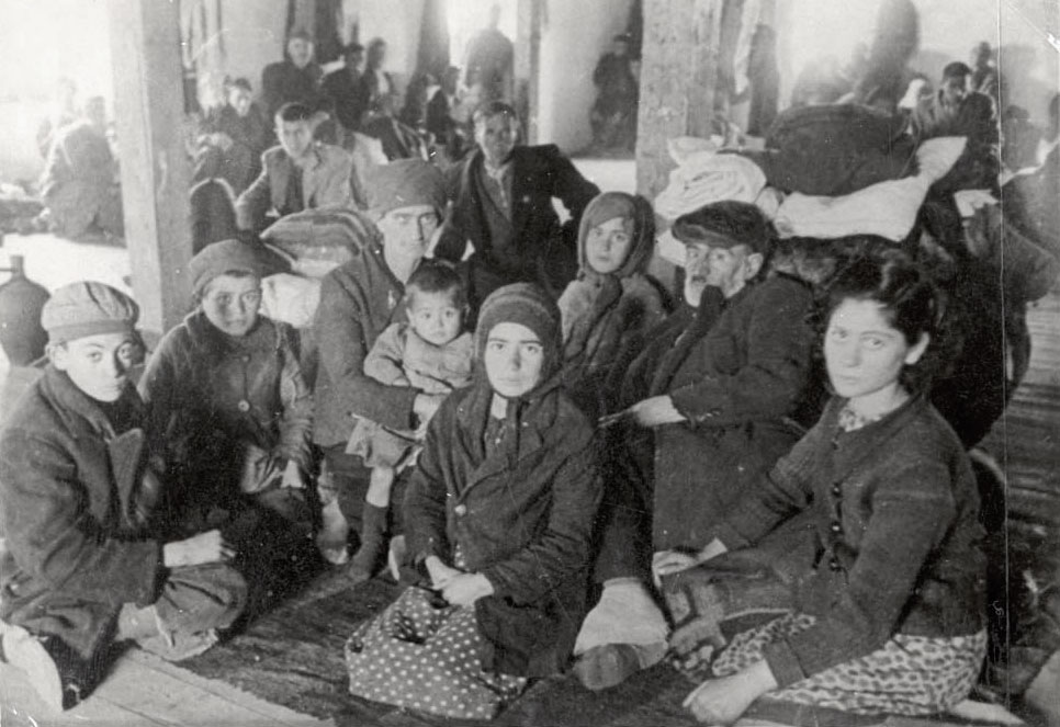 Jews on stools in the “Monopol” tobacco factory storerooms, Skopje, March 1943