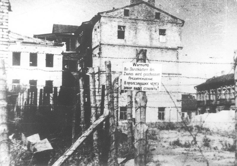 Sign on the Minsk ghetto fence, warning that anyone who tries to escape will be shot