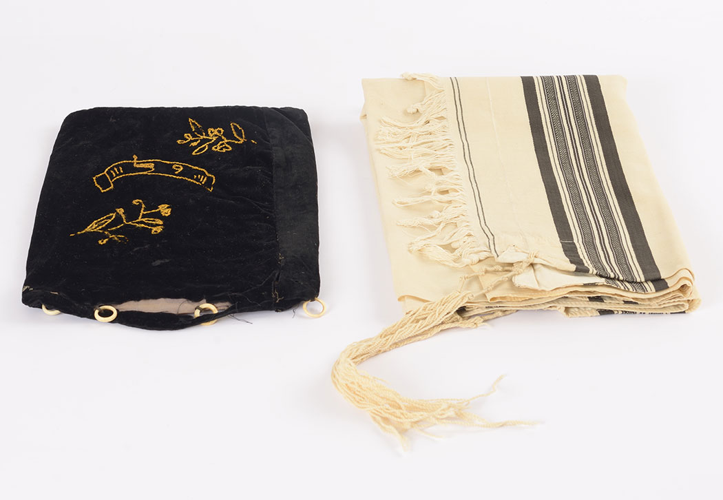 Solomon Krieser's <em>tallit</em> (prayer shawl) and <em>tallit</em> bag, which he sent to his daughters before being deported from Riversaltes to Auschwitz, where he was murdered.