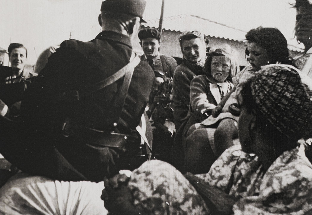 Hilda and Hannah Kreiser leaving Riversaltes on 5 September 1942, after Friedel Bohny-Reiter obtained the permit to return the sisters to Pringy.  The girls are on a truck leaving the camp, accompanied by a policeman whose back is to the photo.  The identity of the other adults in the photo is unknown, but they are presumed to be Jews from the camp. The photo was probably taken by Friedel.