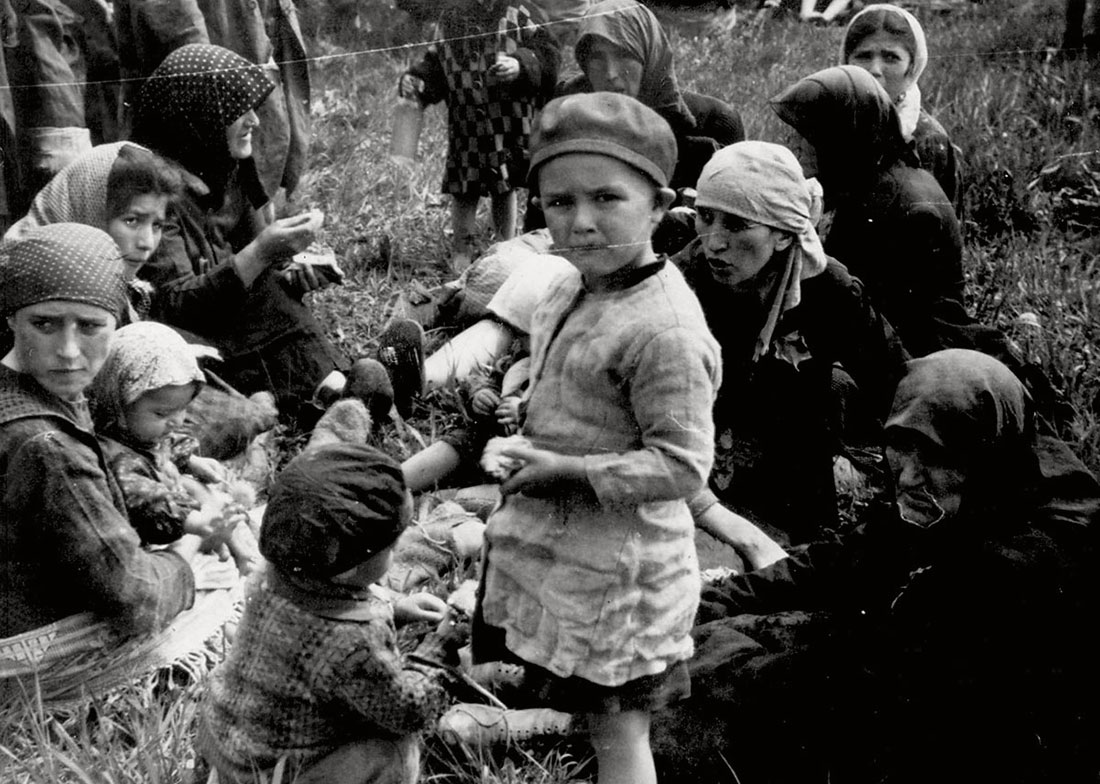 Jews who were classified as “not fit for work” waiting in a grove   outside Crematoria IV before they were to be gassed
