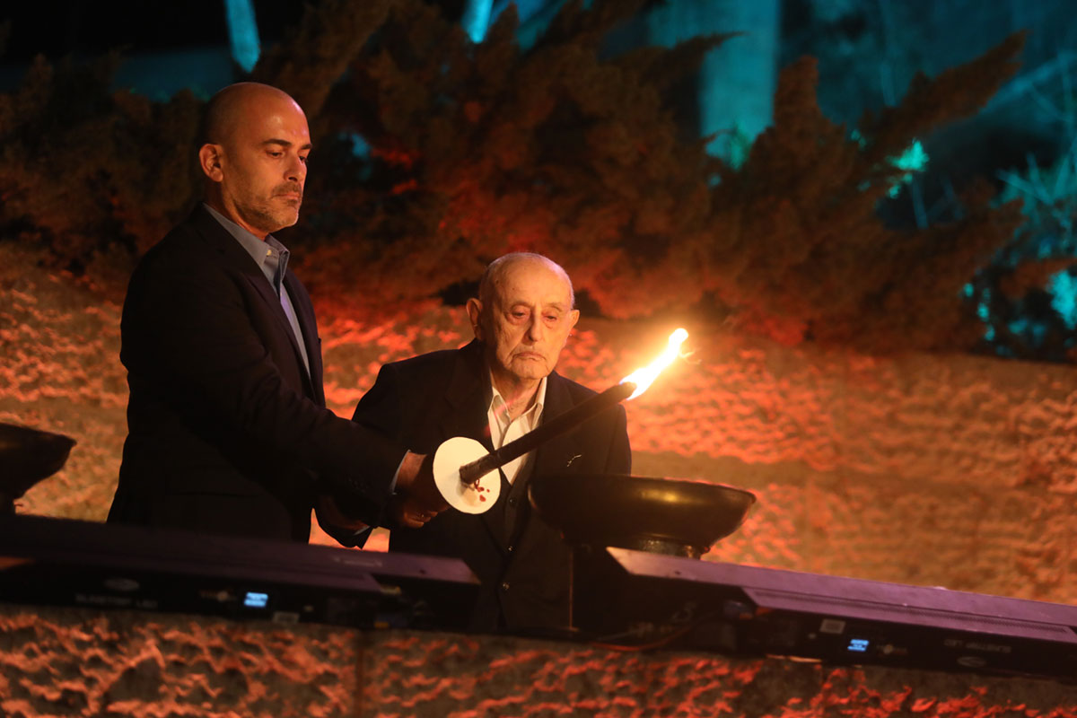Holocaust survivor Arie Shilansky lights one of the six torches at the ceremony