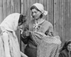 Берген-Бельзен, Германия, апрель 1945. Освобожденные узницы лагеря получают одежду.